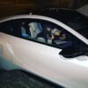 Conor McGregor in a BMW i8 pointing an air-soft gun