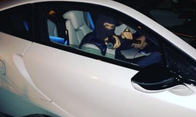 Conor McGregor in a BMW i8 pointing an air-soft gun