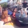 Guy stand on Lamborghini windshield